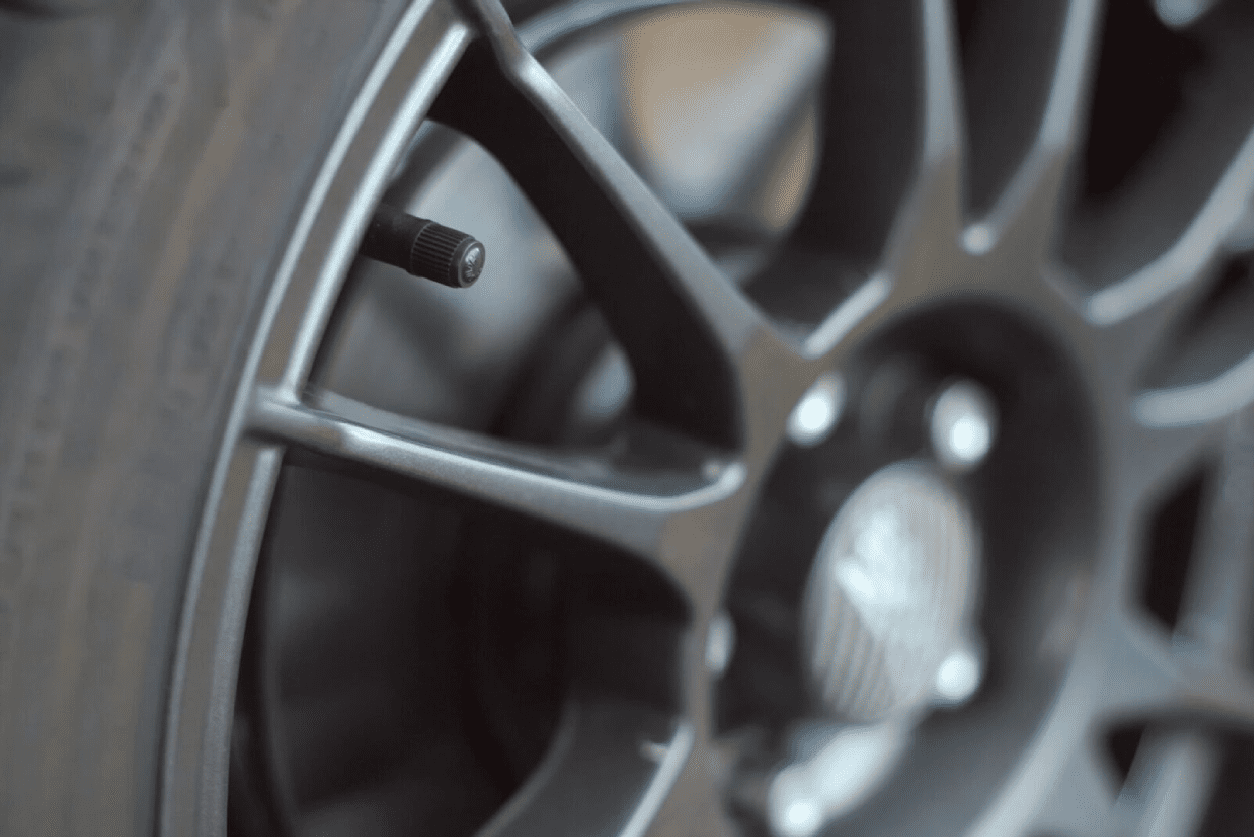 A close up of the rim and tire on a car.