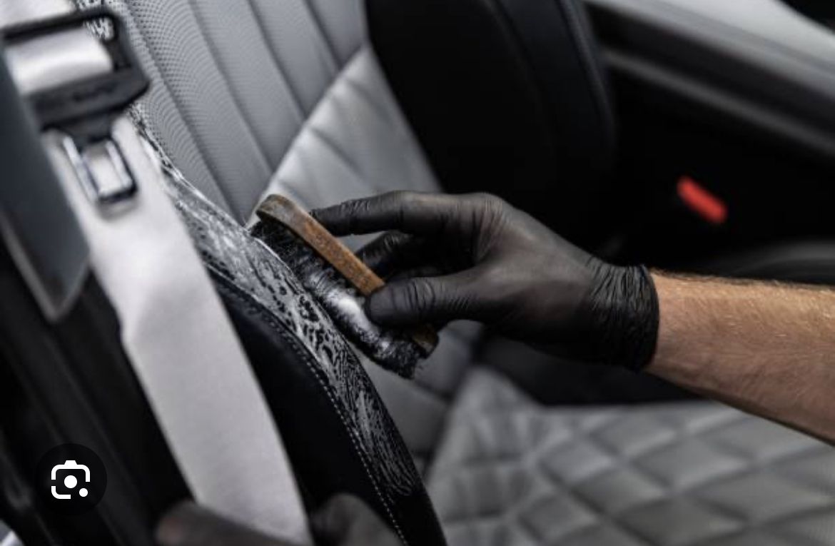 A person in black gloves is holding a knife and some paper