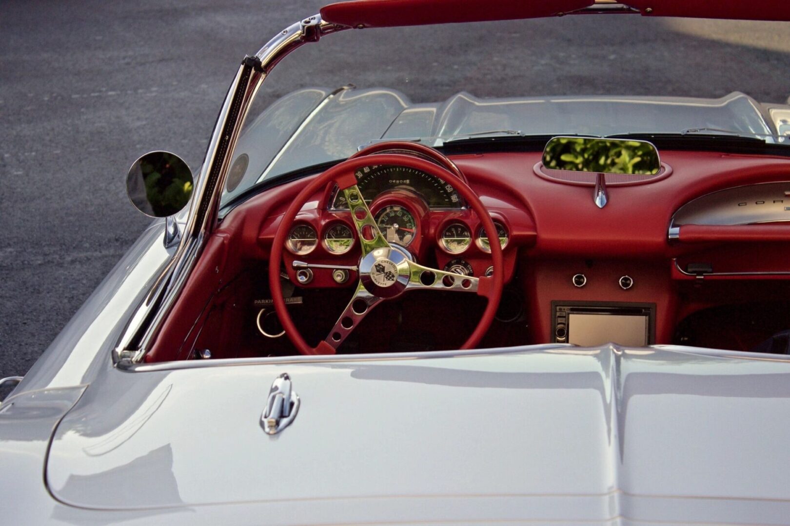 A red and white car with the steering wheel turned up.