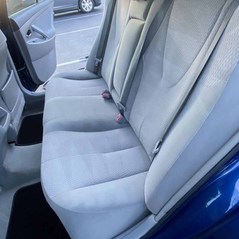 A back seat of a car after cleaning.